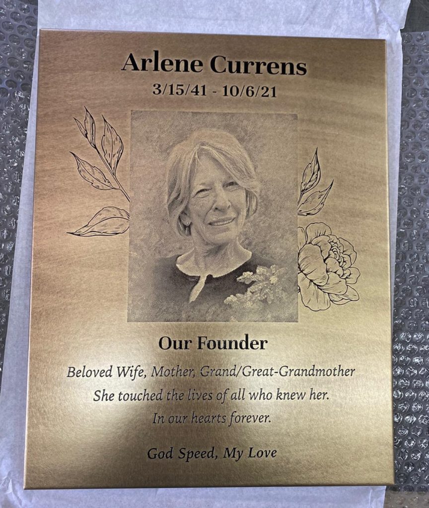 engraved antique style memorial plaque with flowers