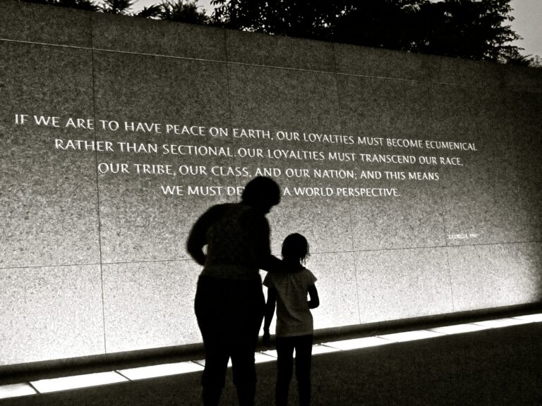 A women and a child looking at a memorial quote