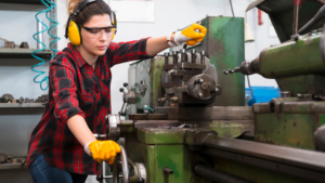 woman works at a milling machine in a Metal manufacturing company